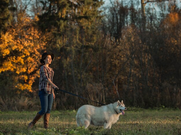 girl walks with husky