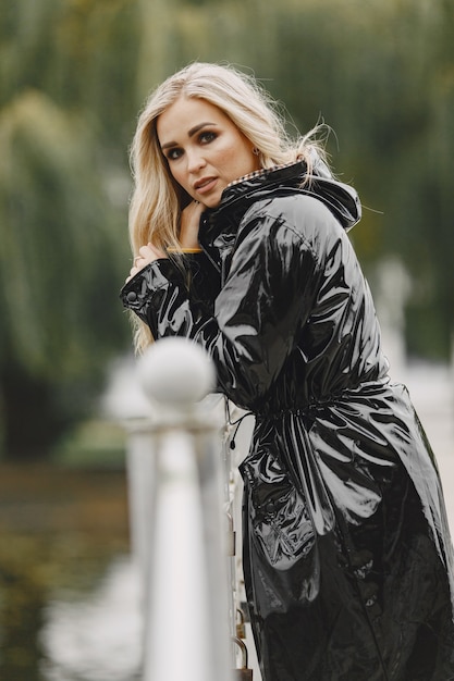 Girl walks. Woman in a black coat.