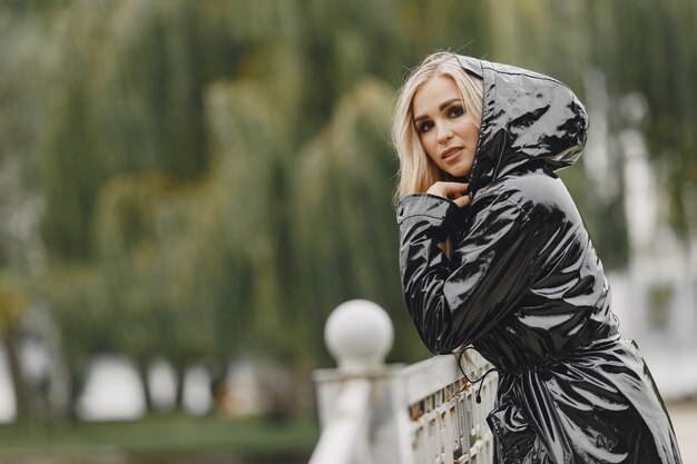 Girl walks. Woman in a black coat.