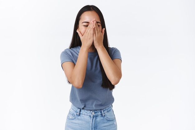 Free photo girl want sneeze so cover nose and put hands on face ahchoo close eyes laughing out loud from funny hilarious joke standing white background joyful having fun enjoying best party ever