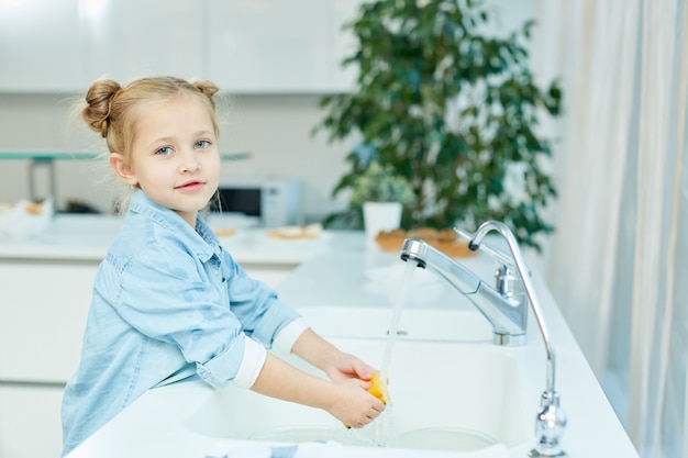 Girl washing dishes