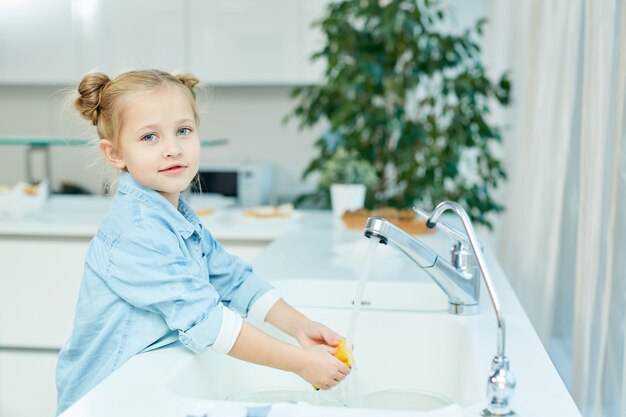 Girl washing dishes