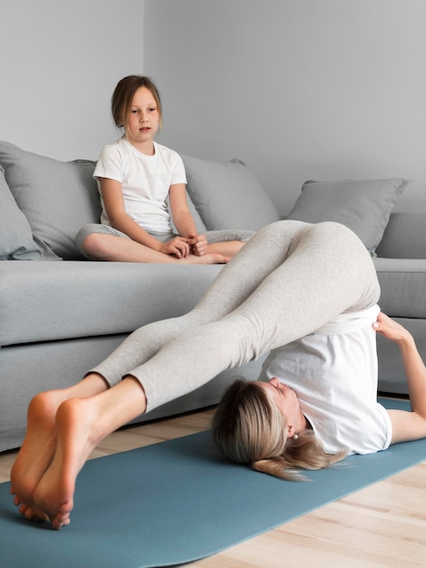 Girl watching mom exercising