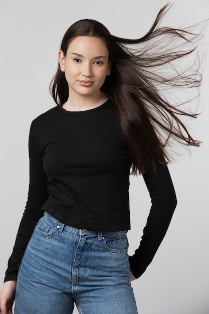 Girl wearing black t-shirt posing in studio