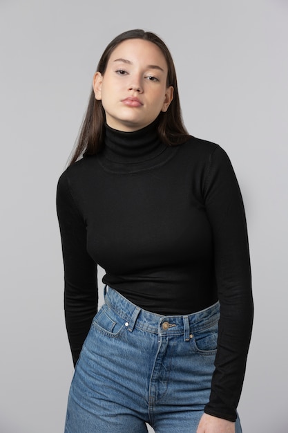 Girl wearing black turtleneck posing in studio