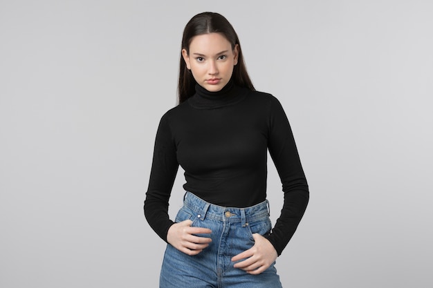 Girl wearing black turtleneck posing in studio