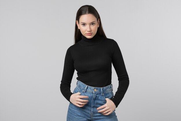 Girl wearing black turtleneck posing in studio