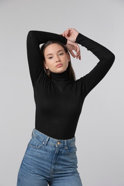 Girl wearing black turtleneck posing in studio