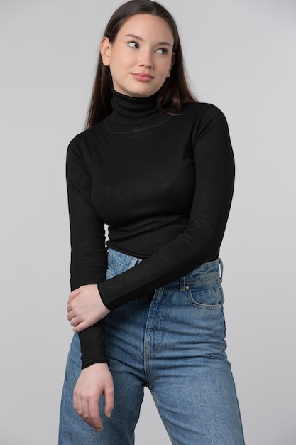 Girl wearing black turtleneck posing in studio