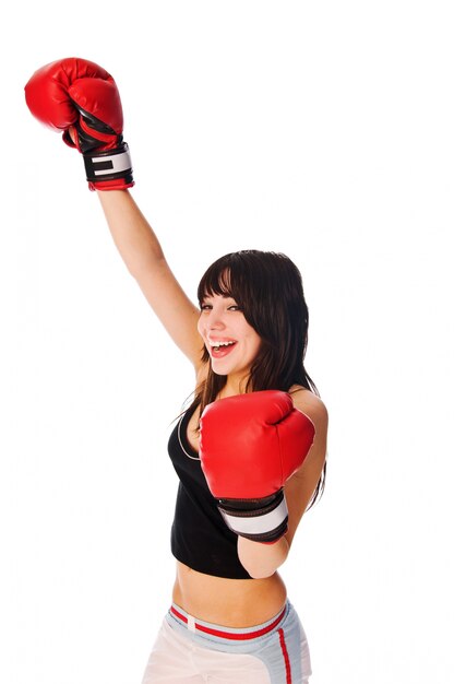 Girl wearing boxing gloves with a rised hand