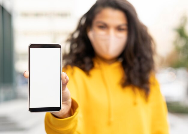 Girl wearing face mask on street with copy space