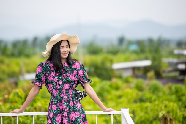 Girl wearing a floral dress on the balcony