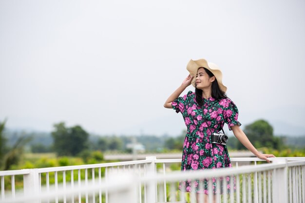Girl wearing a floral dress on the balcony