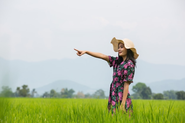 Girl wearing a floral dress standing on a meadow