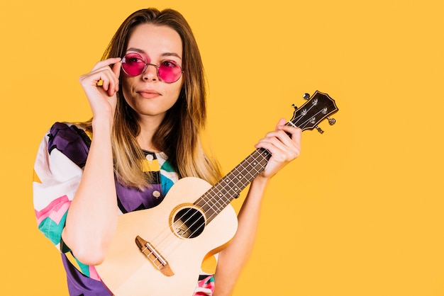 Girl wearing glasses with an ukelele