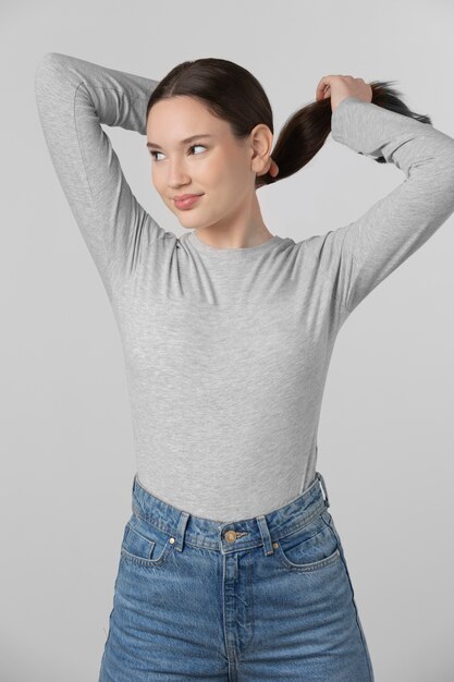 Girl wearing grey t-shirt posing in studio