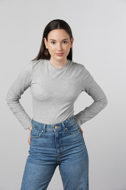 Girl wearing grey t-shirt posing in studio