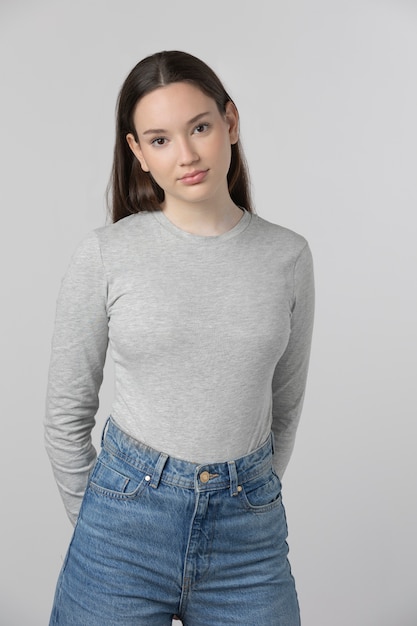 Girl wearing grey t-shirt posing in studio