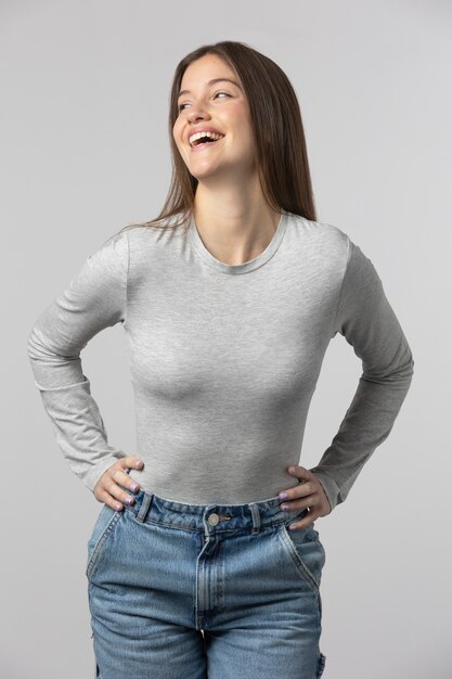 Girl wearing grey t-shirt posing in studio