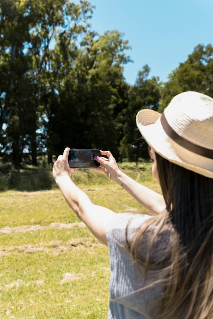 Girl wearing hat taking a selfie