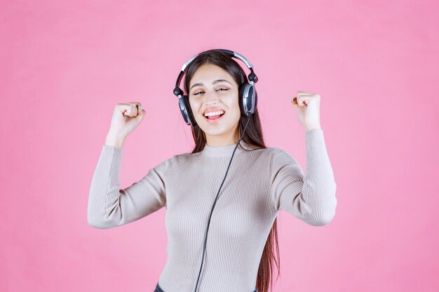 Girl wearing headphones and enjoying the music