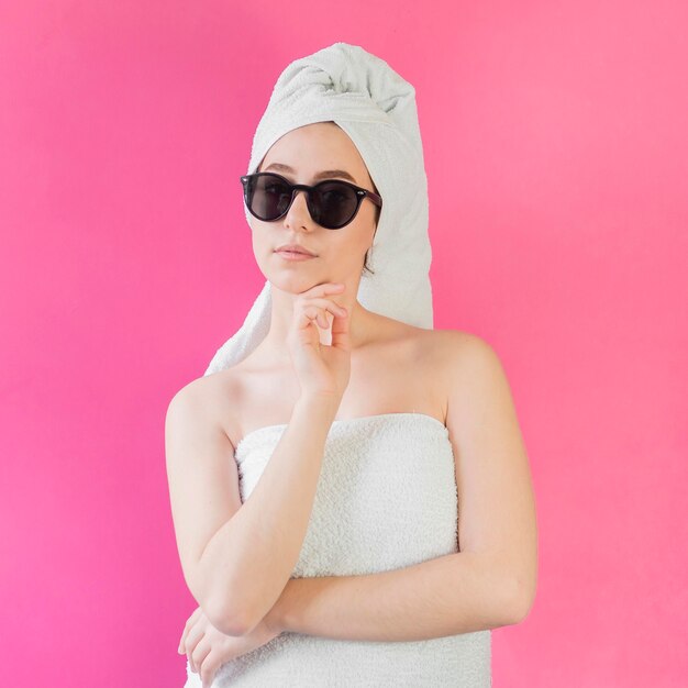 Free photo girl wearing a towel and sunglasses