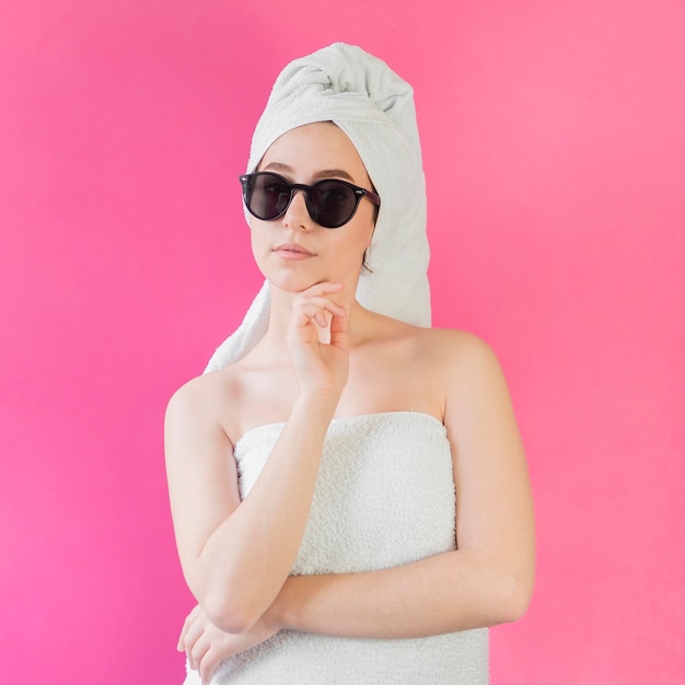 Girl wearing a towel and sunglasses