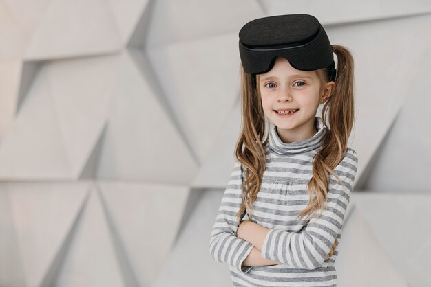 Girl wearing virtual reality headset and smiles