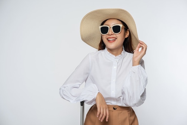 Girl wearing a white shirt and shorts wearing a hat Wear glasses and handle on the hat