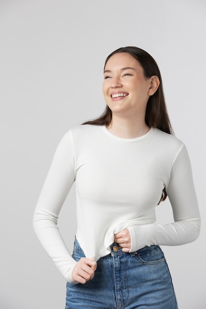 Girl wearing white t-shirt posing in studio