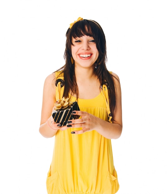 Girl wearing yellow dress with a gift box