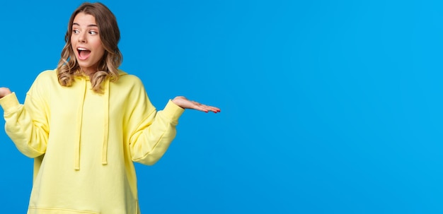 Free photo girl weighing two choices as making decision look away picking between products she holding in arms