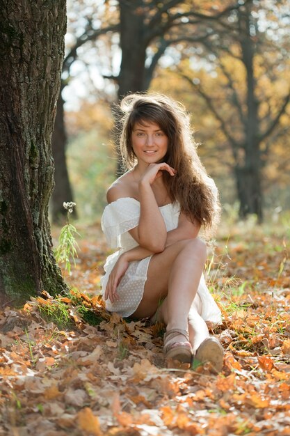 girl in white dress at autumn park