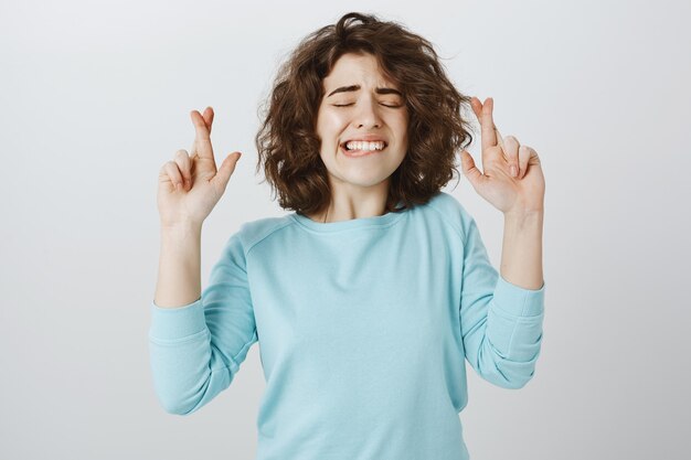 아래 마음에서 바라는 소녀, 눈을 감고 손가락을 교차하십시오.