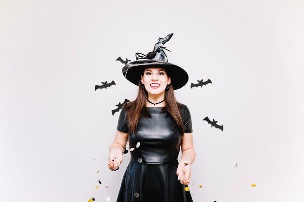 Girl in witch hat with confetti