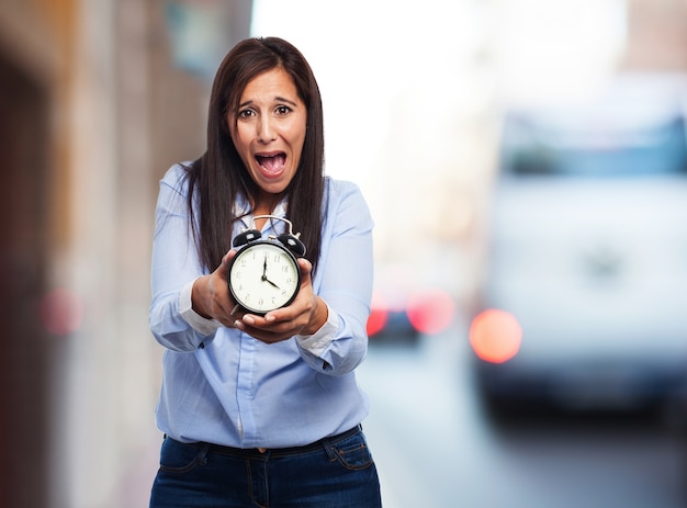 Free photo girl with a alarm clock