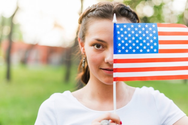 Girl with american flag in front of face