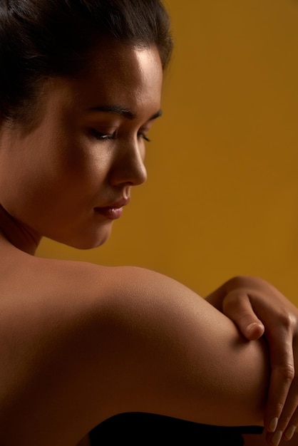 Free photo girl with bare back sitting looking down