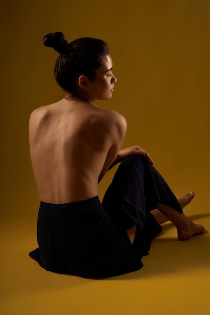 Girl with bate back stretching on floor