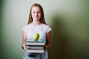 Free photo girl with books and apple