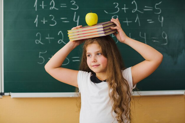 Girl with books on head