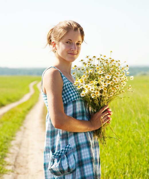 girl with bouquet of camomiles