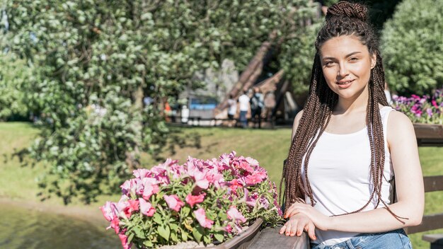 Girl with box braid hairstyle and flower pot