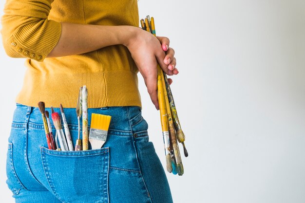 Girl with brushes in the pocket