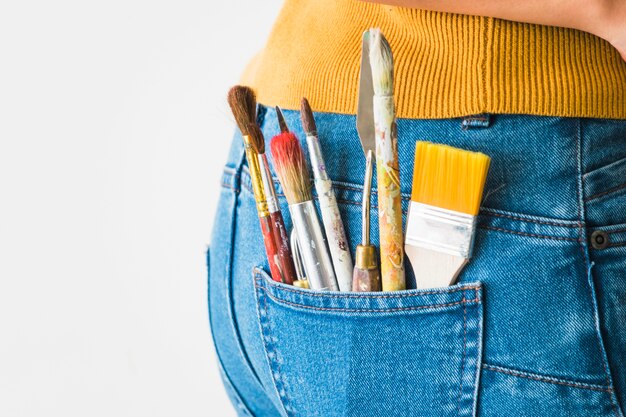 Girl with brushes in the pocket