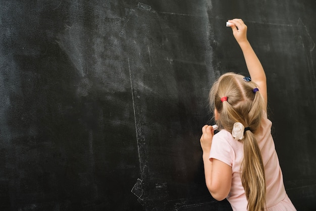 Girl with chalk in class