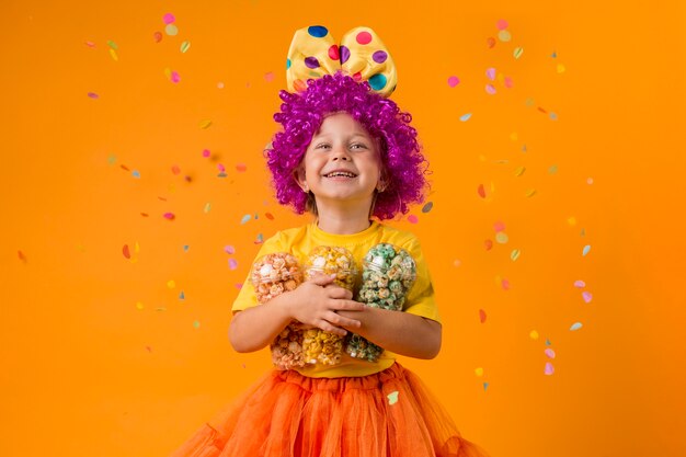 Girl with clown costume and candy