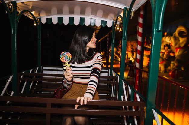 Girl with colorful lollipop on a ride
