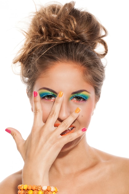 Foto gratuita ragazza con manicure colorata e trucco
