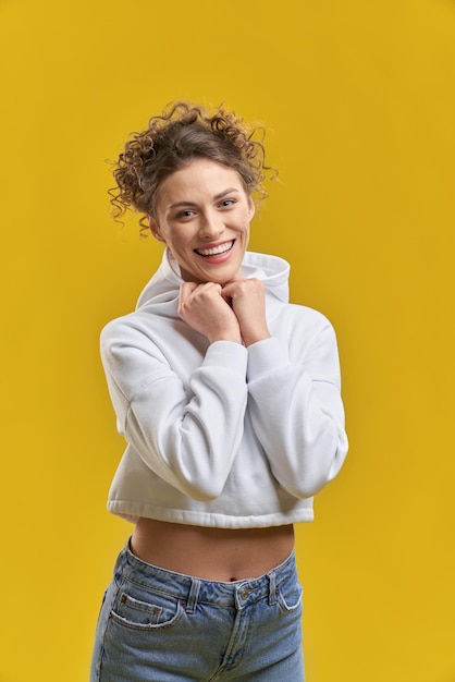 Girl with curly hair standing smiling